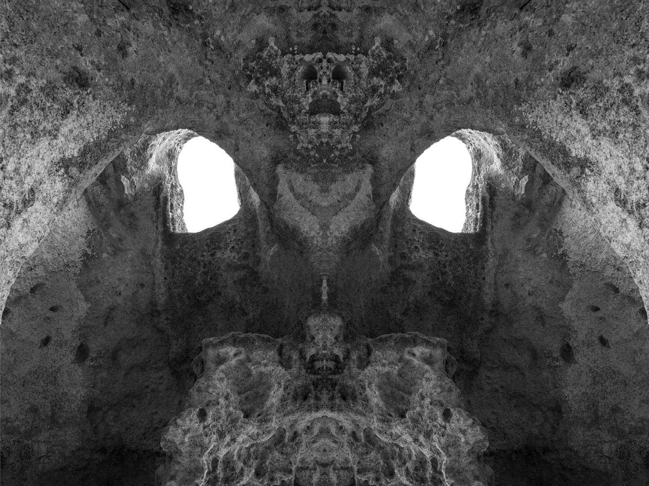Dark symmetrical cave interior resembling a mask
