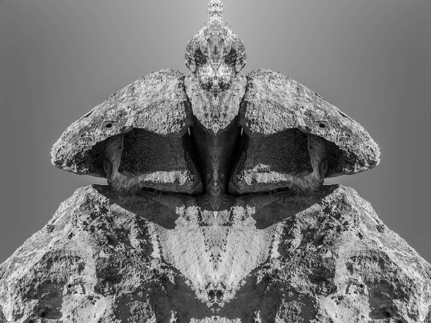 Symmetrical limestone formation resembling a masked figure