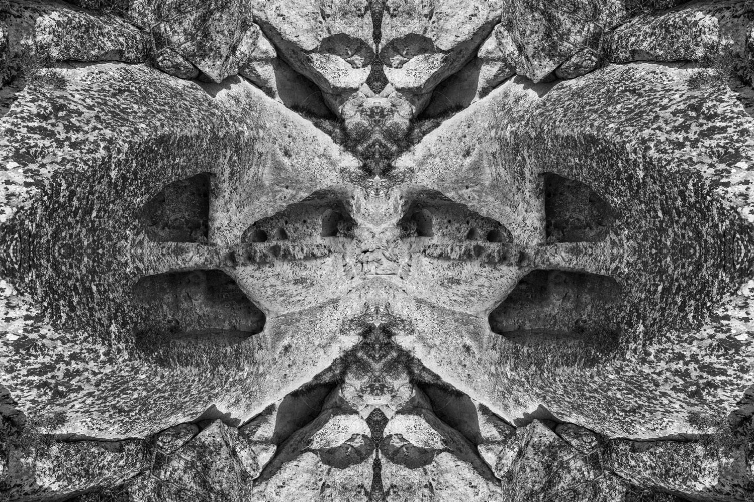 Mirrored rock chambers forming a watchful face