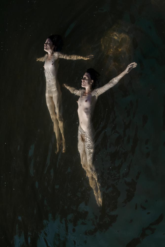 Floating figures in water — photograph 01