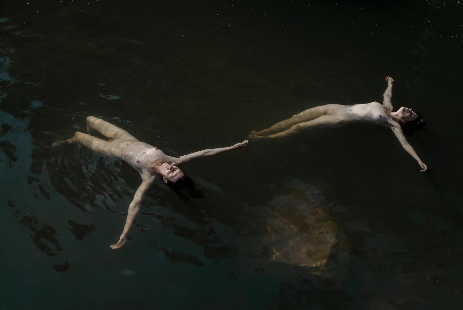 Floating figures in water — photograph 02