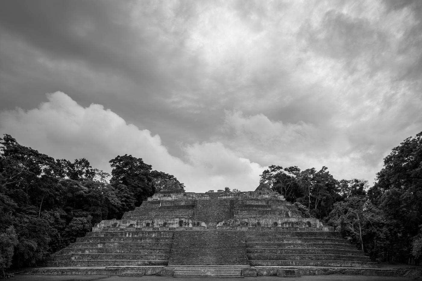 The great Maya temple at Caracol beneath a dramatic sky